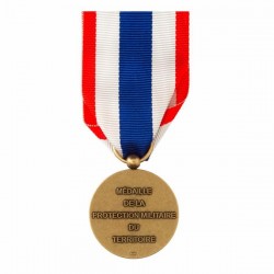 Sur le revers de la médaille de protection militaire , l'inscription "Médaille de la Protection Militaire du Territoire".